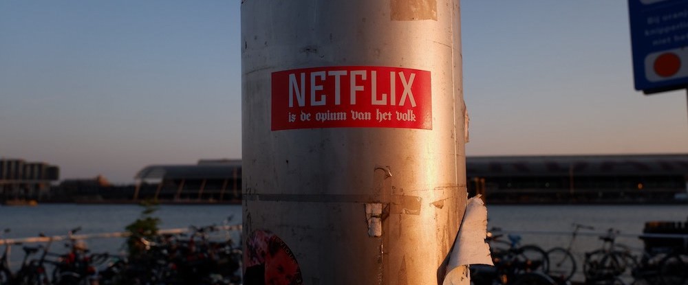 'Netflix is the opium of the people' sticker stuck out in the wild